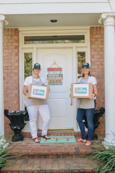 Two women's holding a box