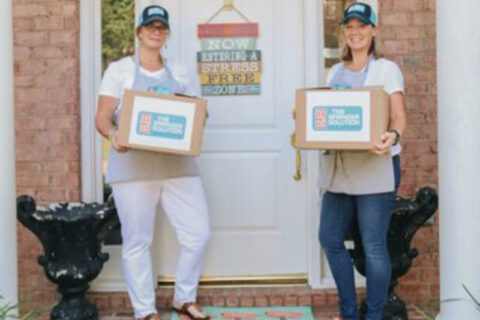 Two women's holding a box